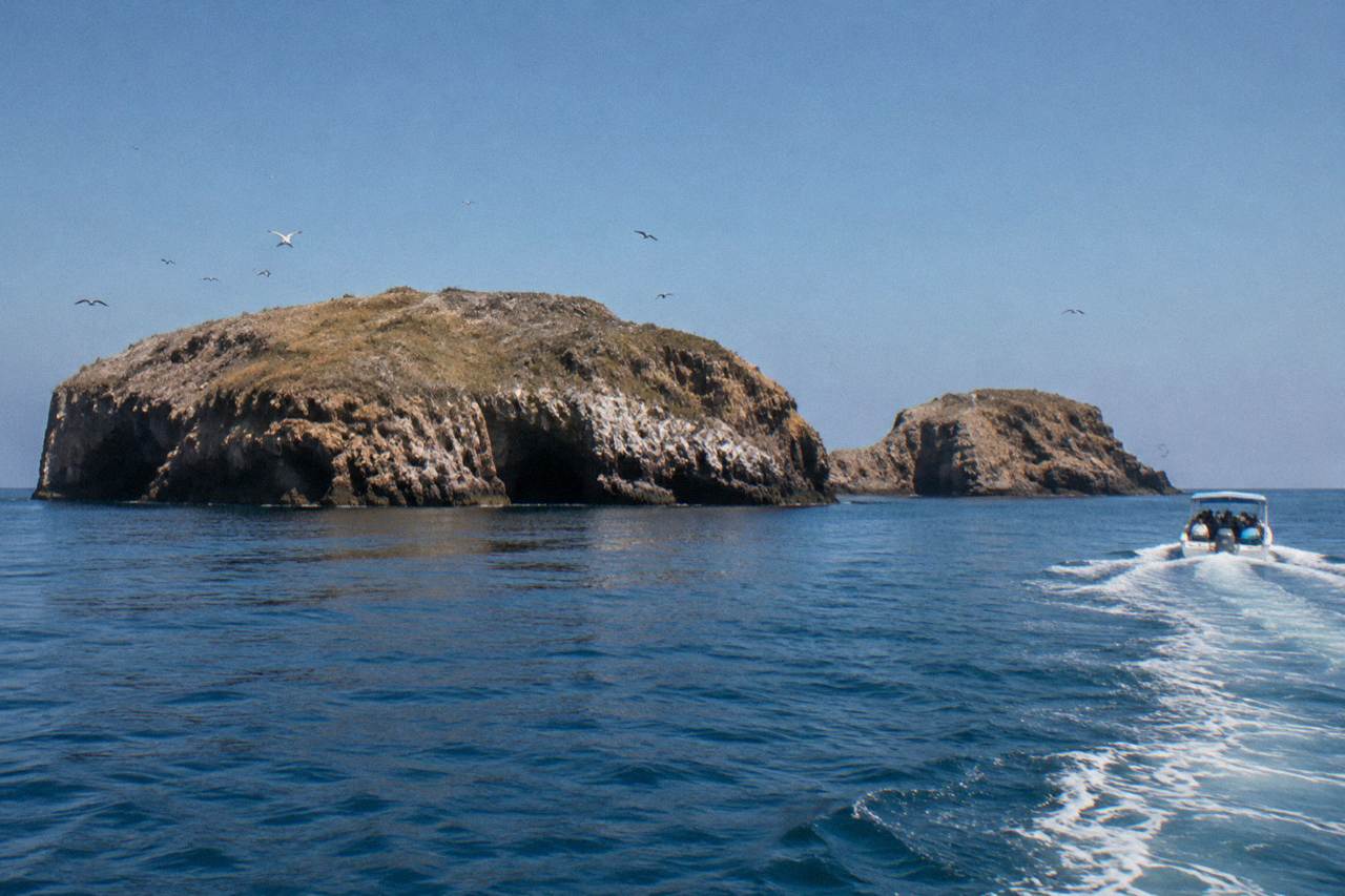 Rocky islands of the Marietas National Park rising from calm blue water under a clear sky