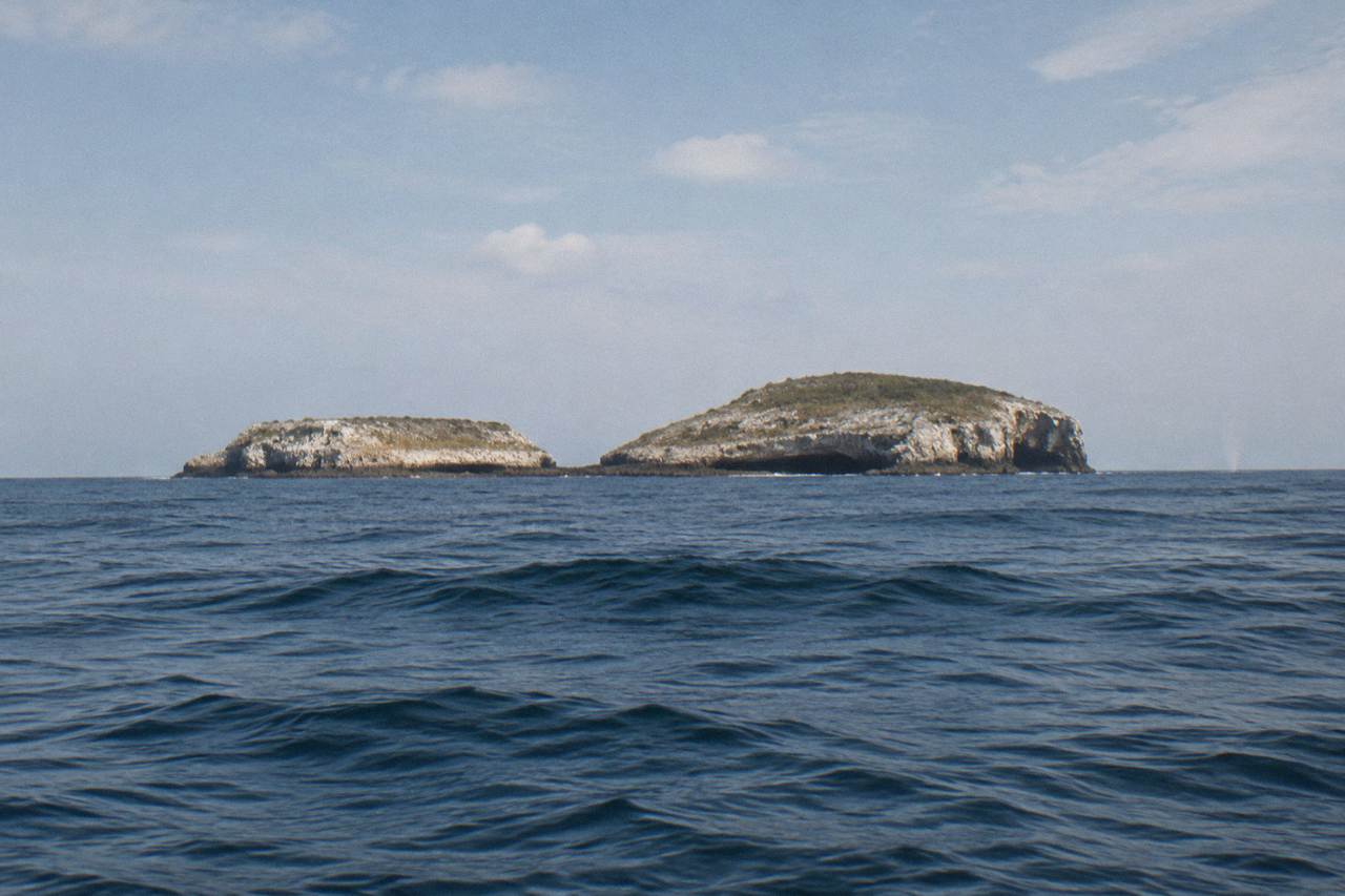 Rocky islands of the Marietas archipelago rising from calm blue water under a wide sky