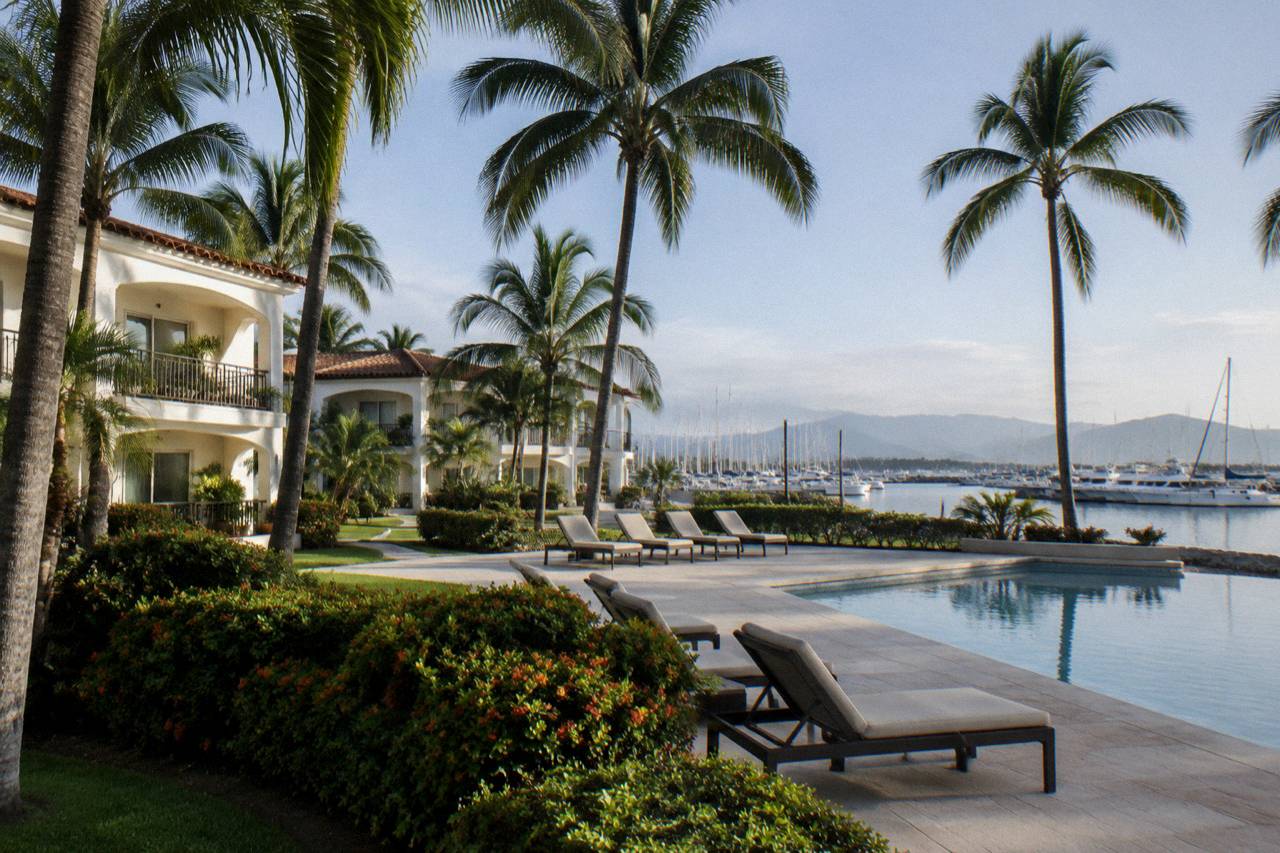 Beachfront hotel grounds with palm trees in Nuevo Vallarta