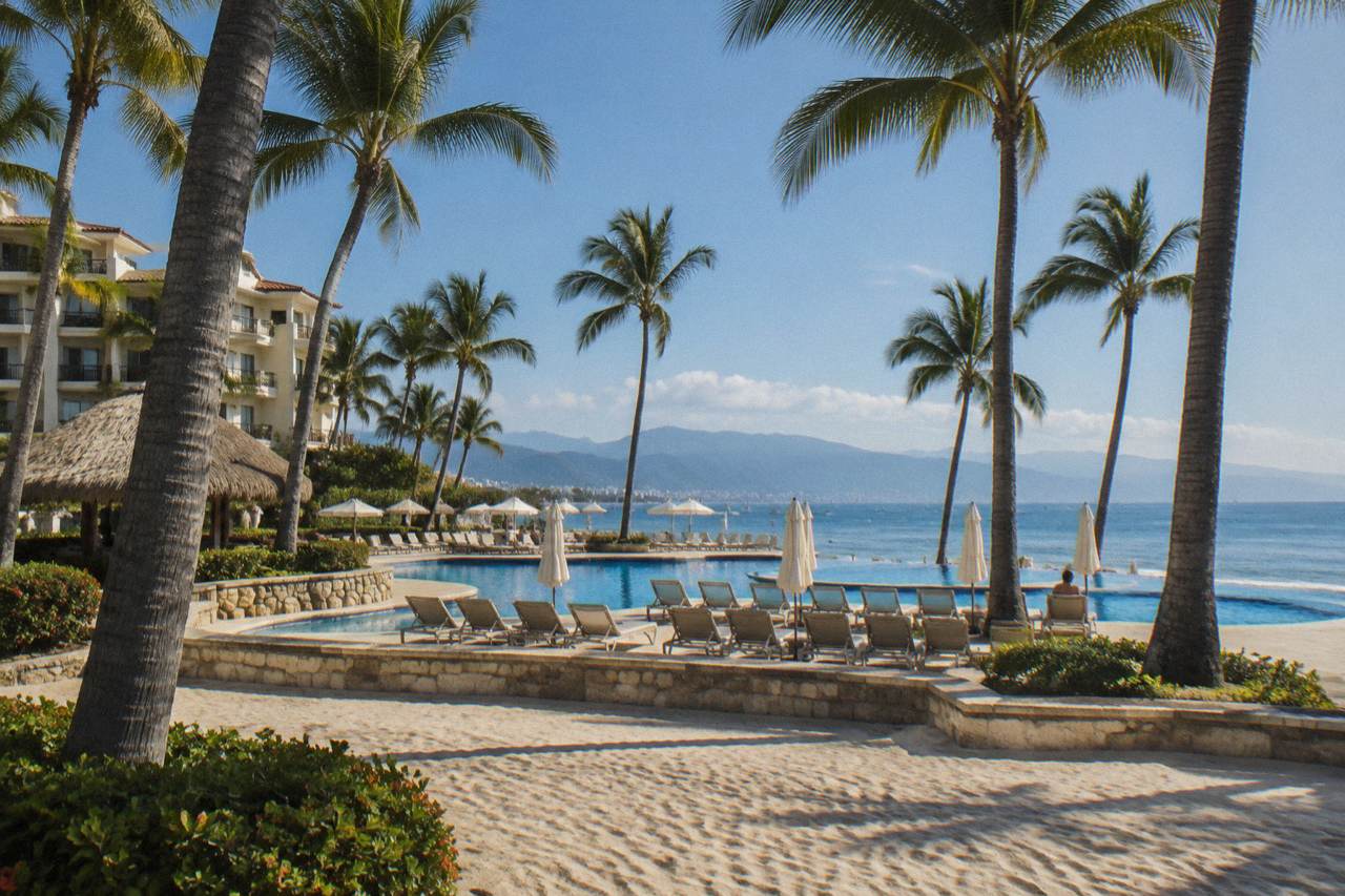 Beachfront hotel grounds with palm trees in Marina Vallarta, Puerto Vallarta